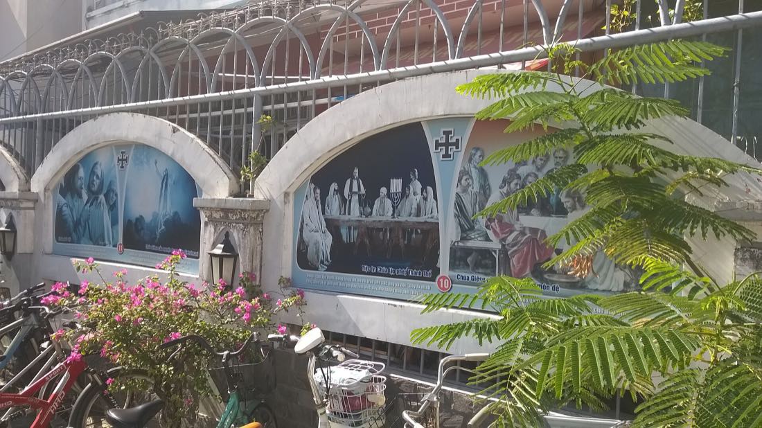 Painted devotional panels in the grounds of Da Nang Cathedral on Tran Phu